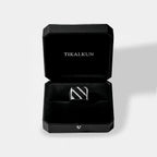 obsidian ring inside a Black jewelry box with 'TIKALKUN' branding on a light gray background
