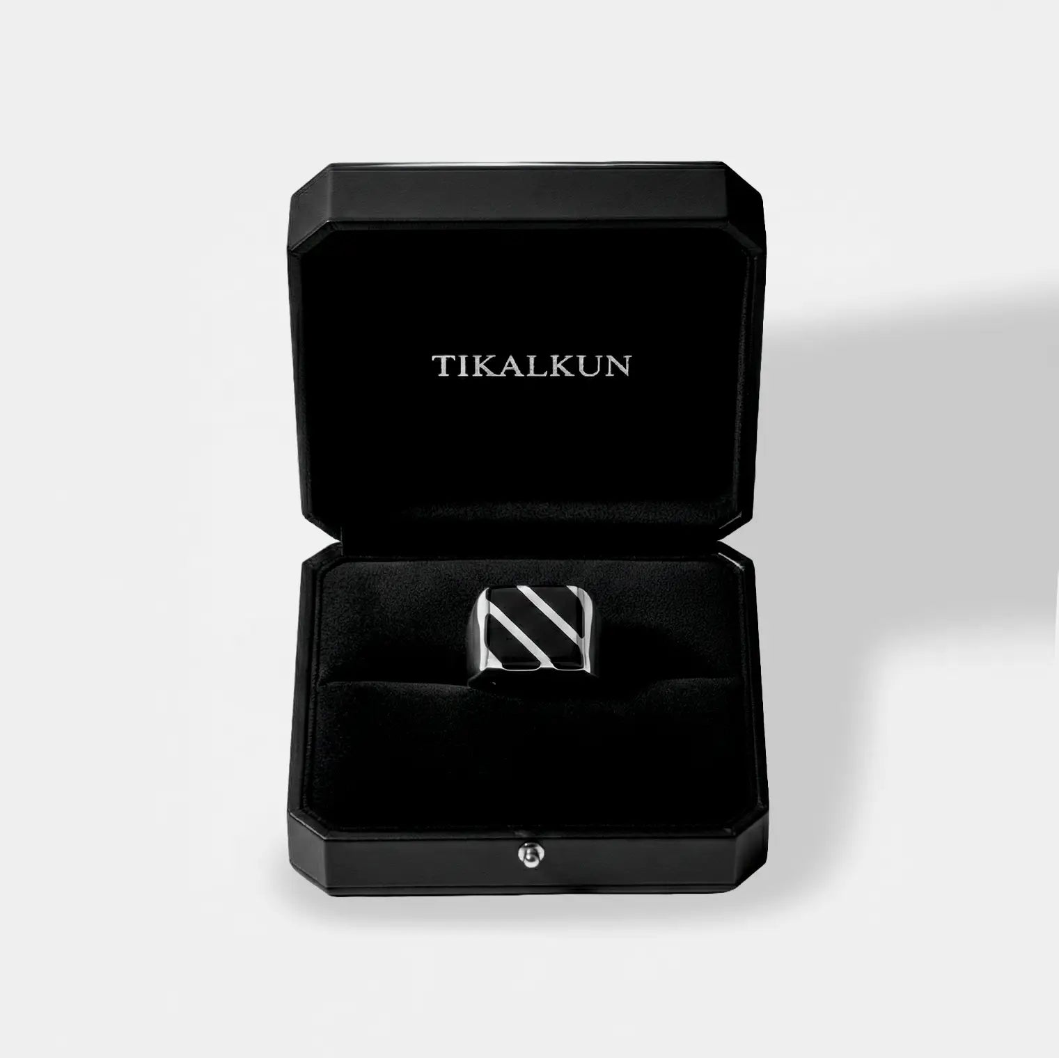 obsidian ring inside a Black jewelry box with 'TIKALKUN' branding on a light gray background