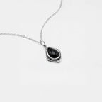 Necklace with a black teardrop pendant on a white background