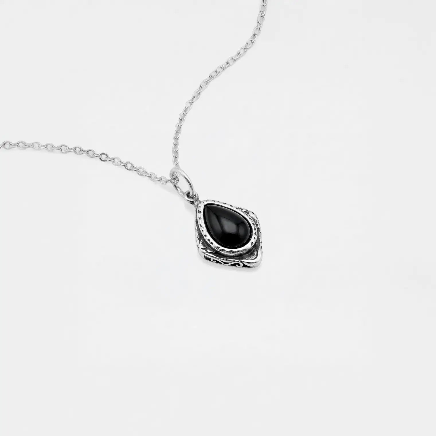 Necklace with a black teardrop pendant on a white background