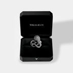Octopus silver ring in a black Tikalkun jewelry box on a light gray background