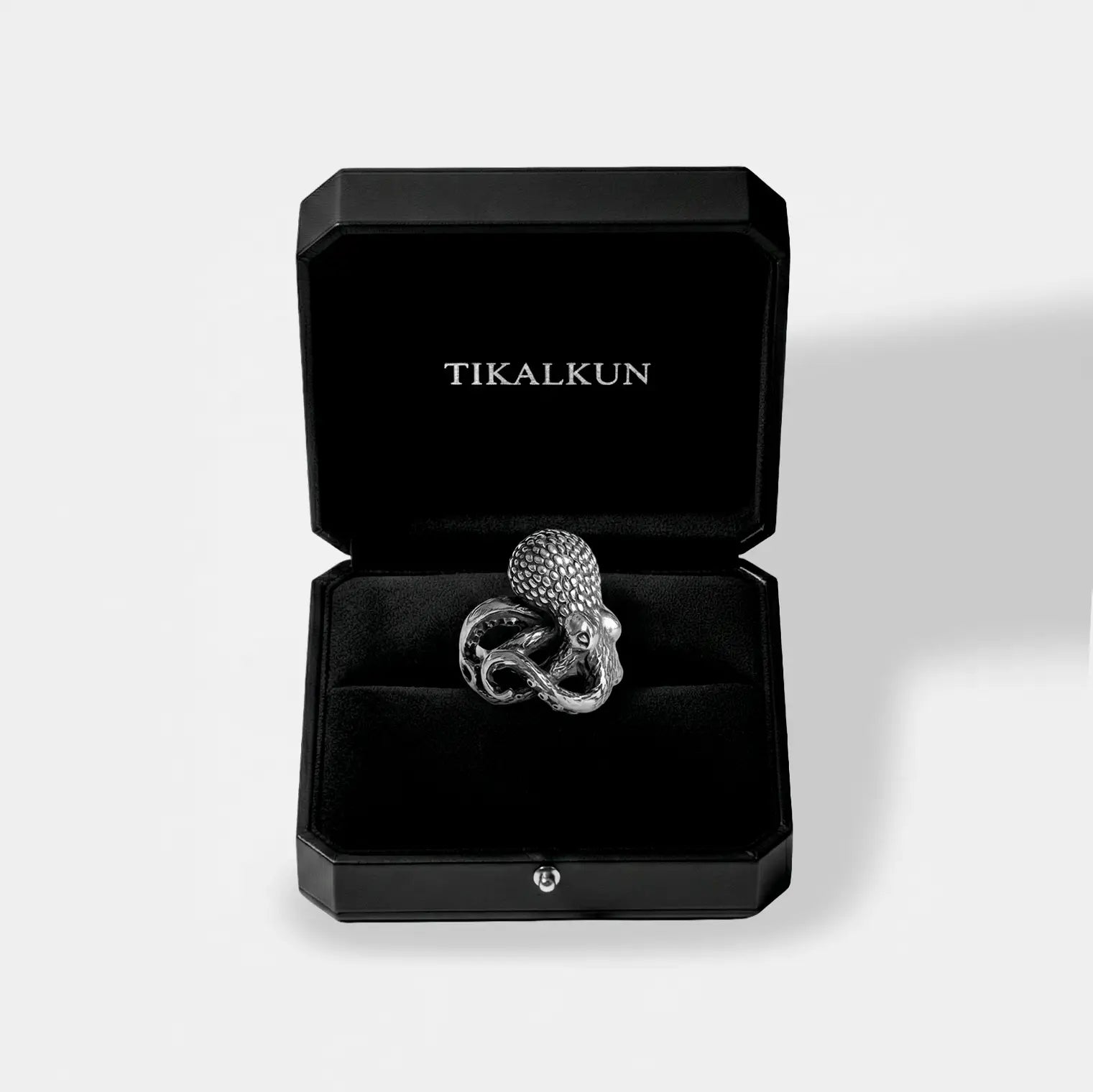 Octopus silver ring in a black Tikalkun jewelry box on a light gray background