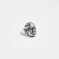 Silver OLMEC HEAD ring on a light gray background