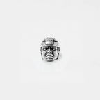 Silver OLMEC HEAD ring on a light gray background