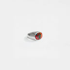 Silver ring with a opal-fire stone on a white background