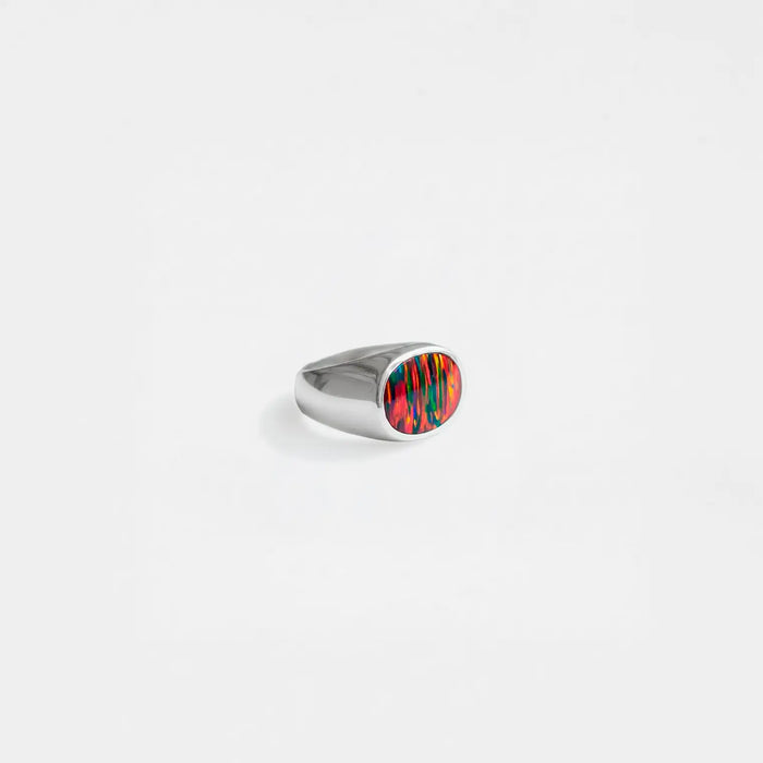 Silver ring with a opal-fire stone on a white background