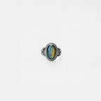 Silver ring with a labradorite gemstone on a white background