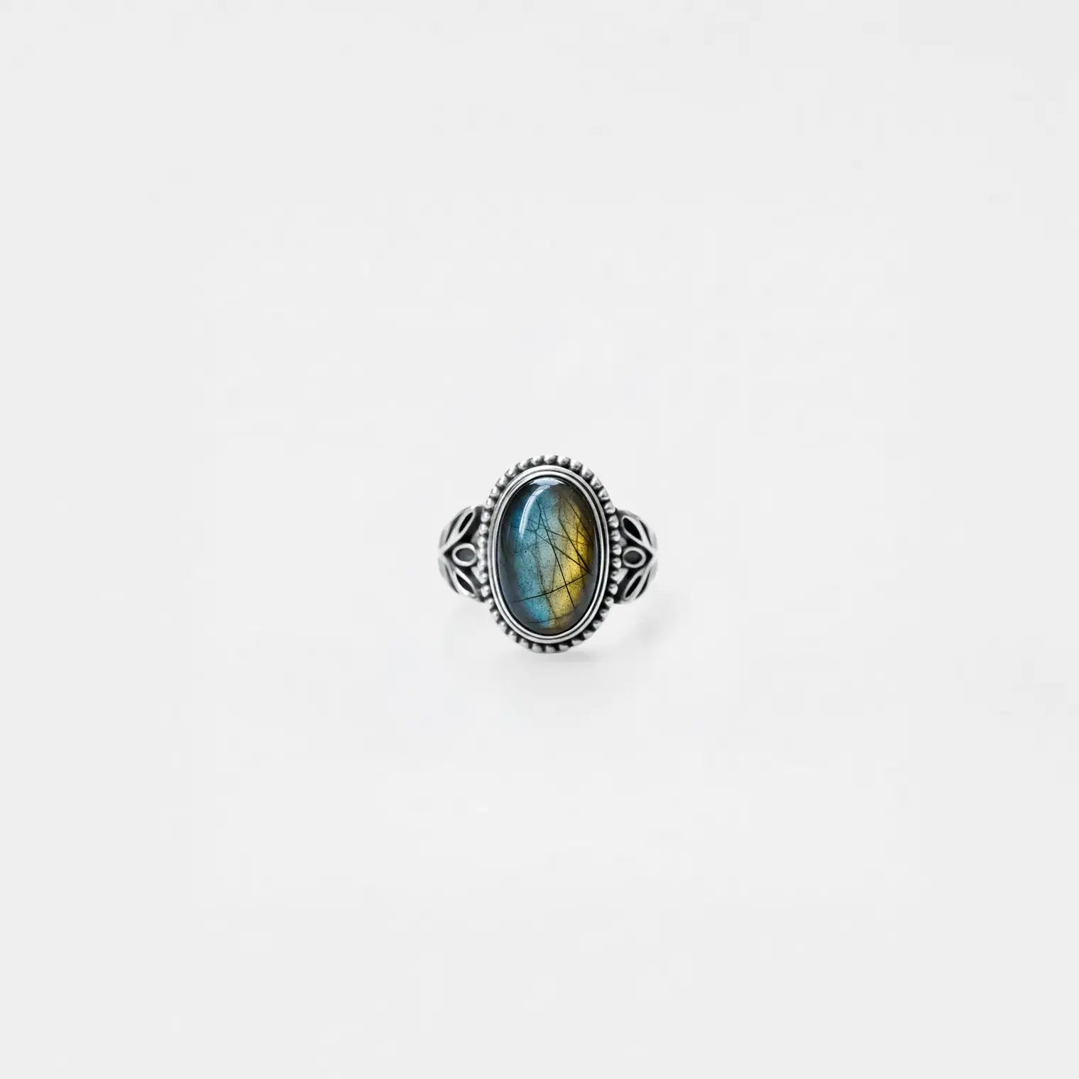Silver ring with a labradorite gemstone on a white background