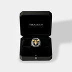 Silver ring with bee design in a black Tikalkun box on a light gray background