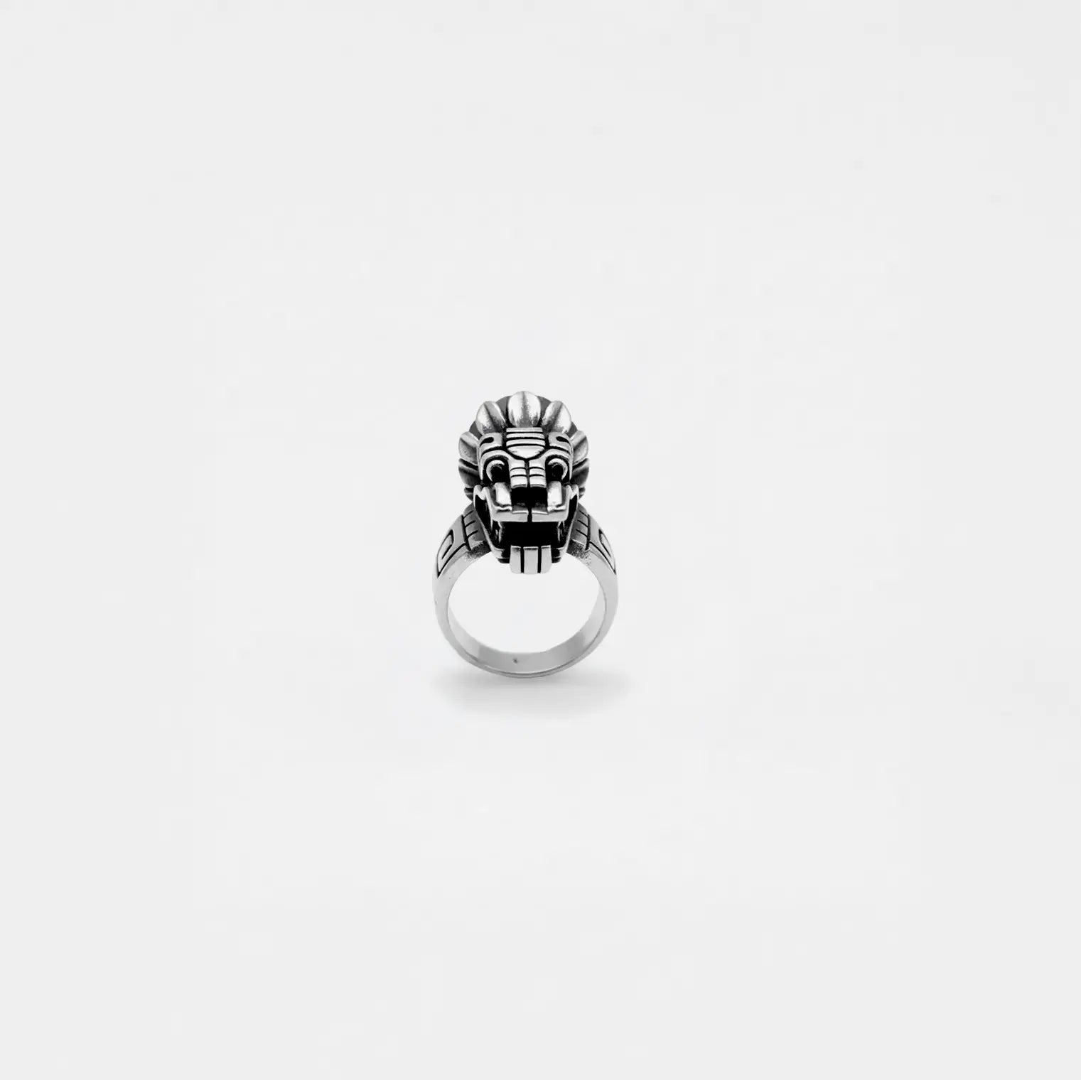 Silver quetzalcoatl ring on a white background