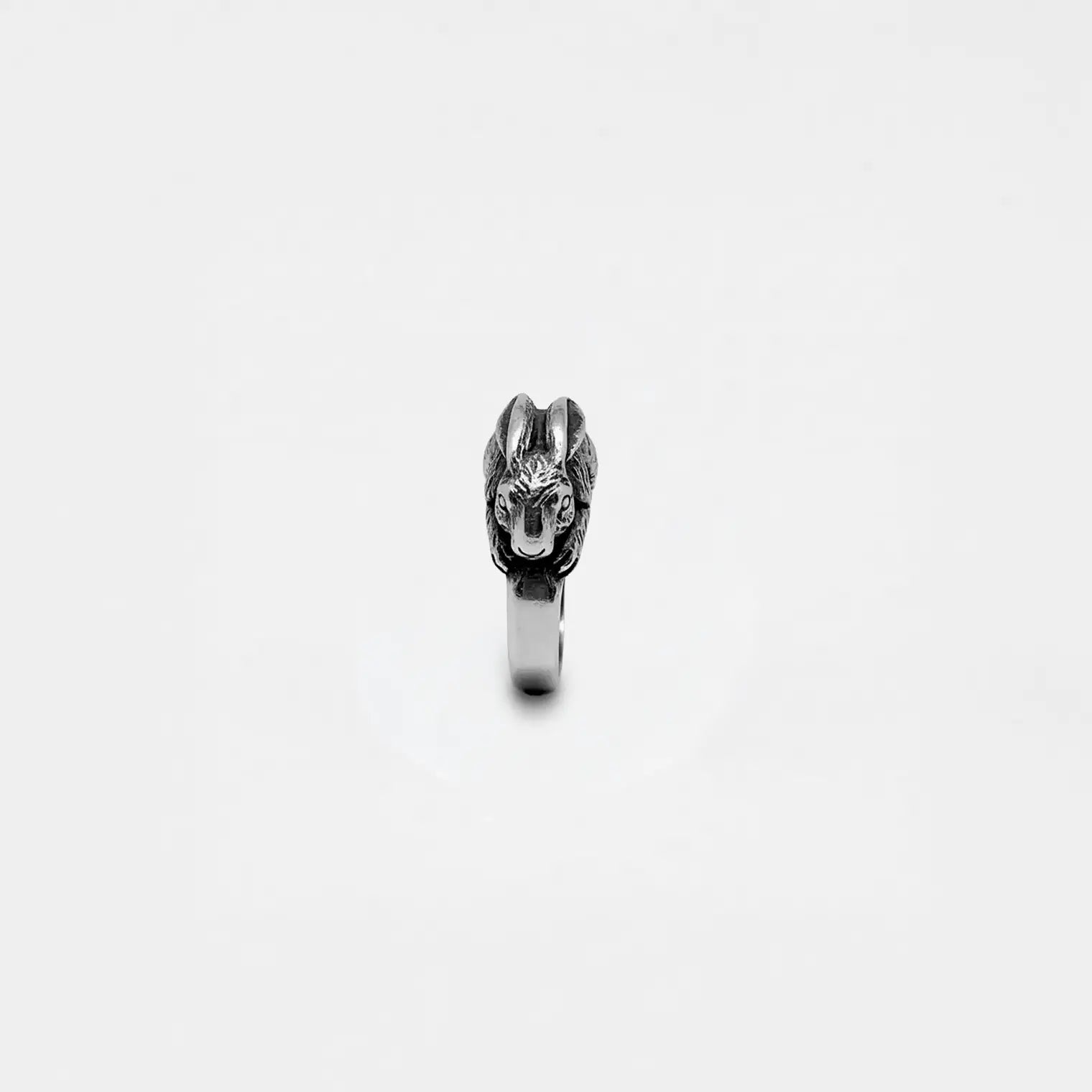 Silver ring with a rabbit design on a white background