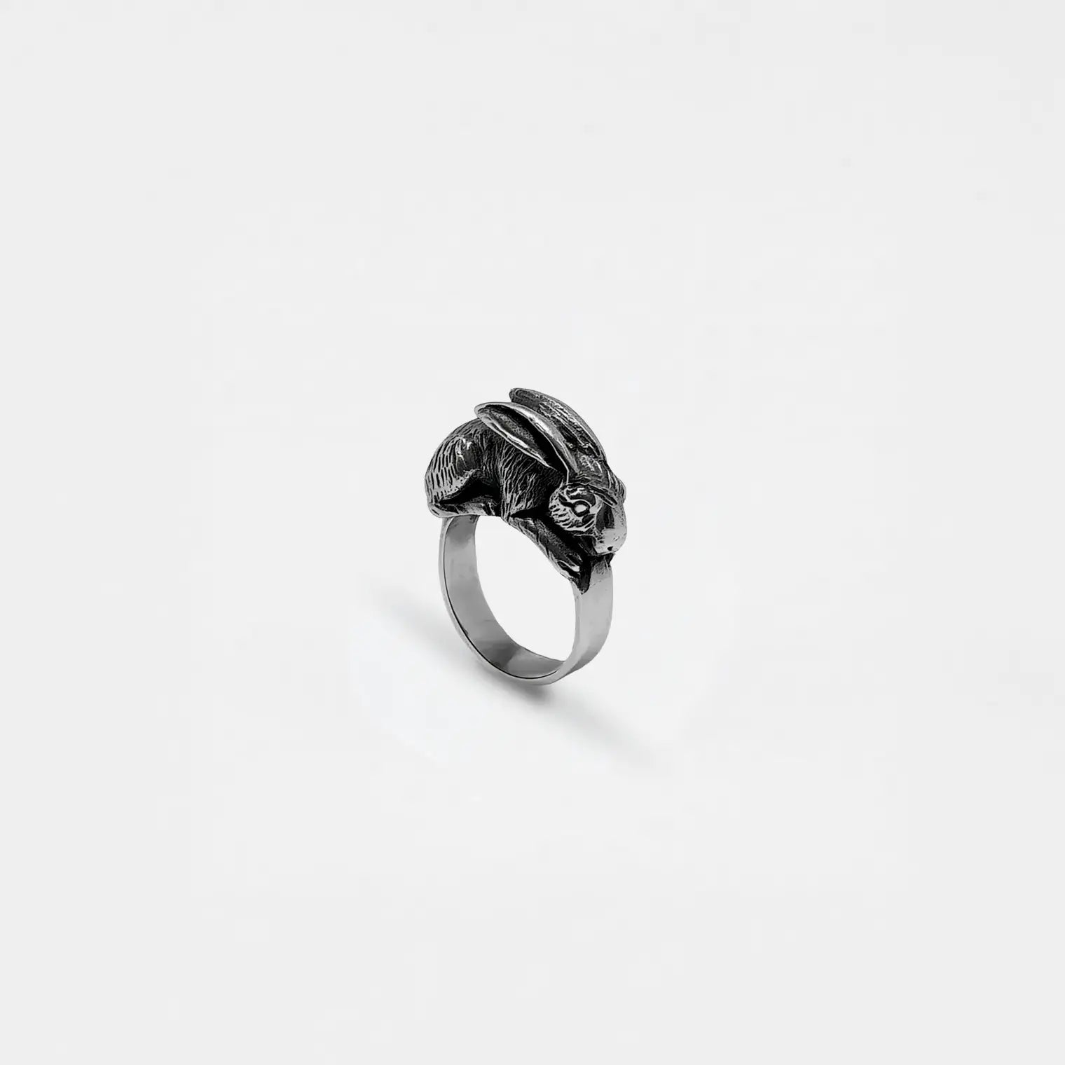 Silver ring with a rabbit design on a white background