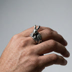 man's hand wearing a Silver rabbit ring on a white background