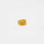 Gold rock-wall ring with a textured design on a white background