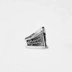 Silver ring with ROMAN architectural design on a white background