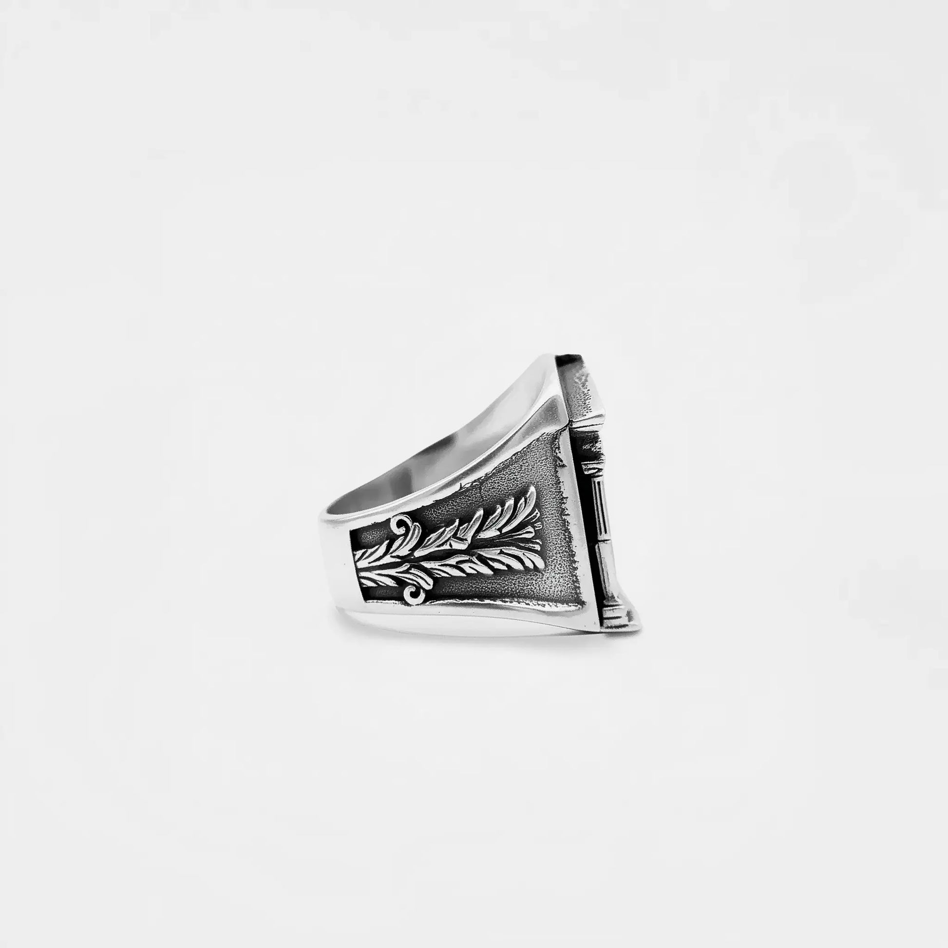 Silver ring with ROMAN architectural design on a white background