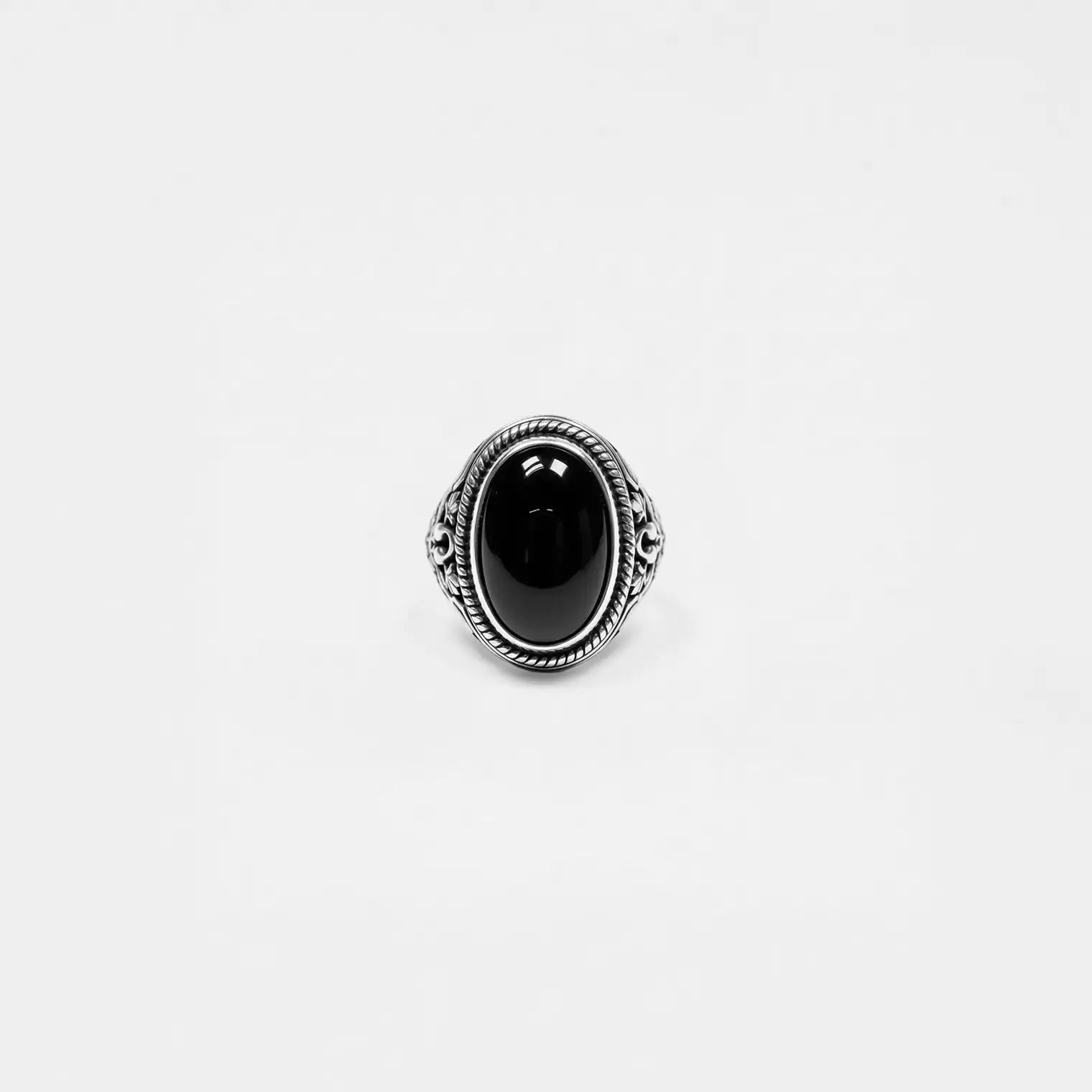 Silver ring with a black gemstone on a white background