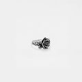 Silver ring with rose design on a white background