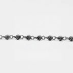 Silver roses bracelet with rose-shaped links on a white background