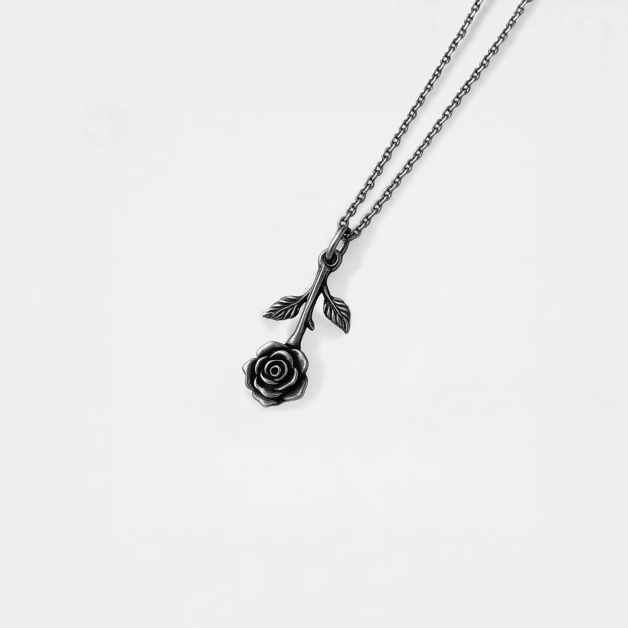 Black rose pendant necklace on a white background