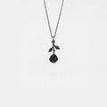 Silver necklace with a rose pendant on a light gray background