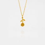 Gold necklace with a rose pendant on a white background