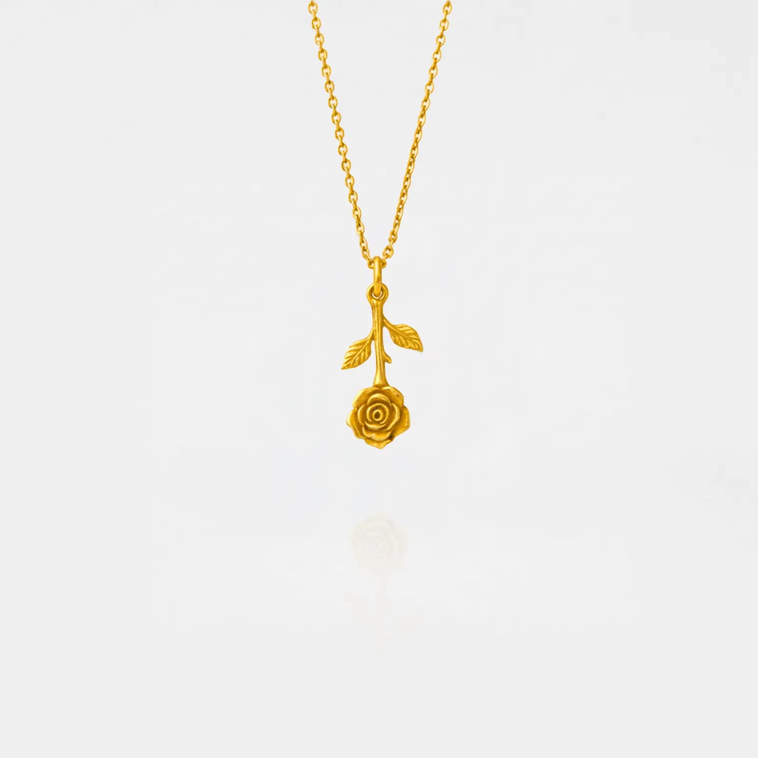 Gold necklace with a rose pendant on a white background