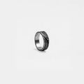 Silver ring with rustic textured band on a light gray background