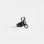 Silver scorpion-shaped ring on a white background