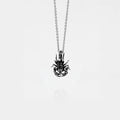 Silver scorpion pendant necklace on a thin chain against a white background