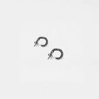 Pair of silver hoop snake earrings on a white background