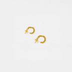 Gold hoop snake earrings on a light gray background