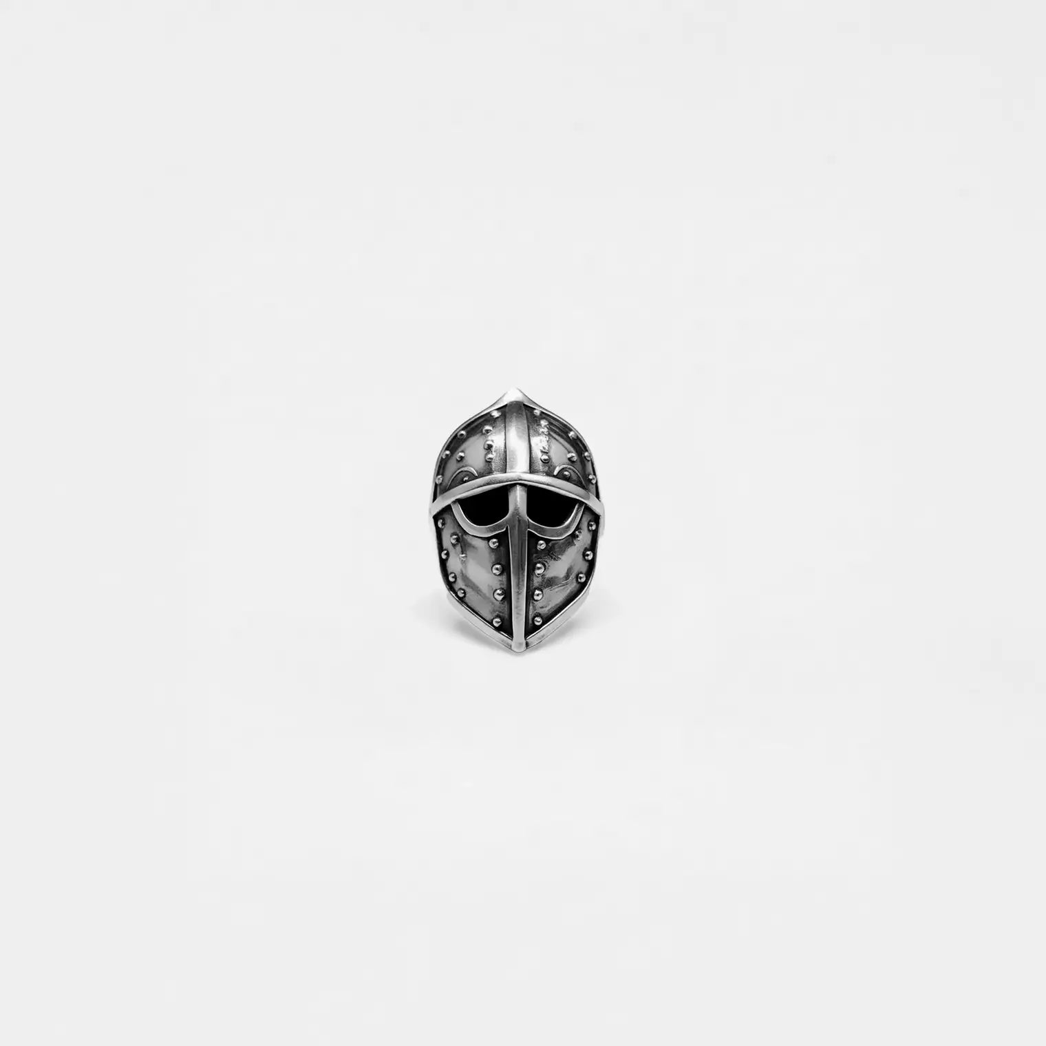 Silver ring with a medieval helmet design on a light gray background