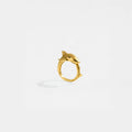 Gold ring with a tiger-shark design on a white background