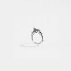 Silver ring with a tiger-shark design on a light gray background