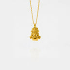 Gold tlaloc necklace with a unique pendant on a white background