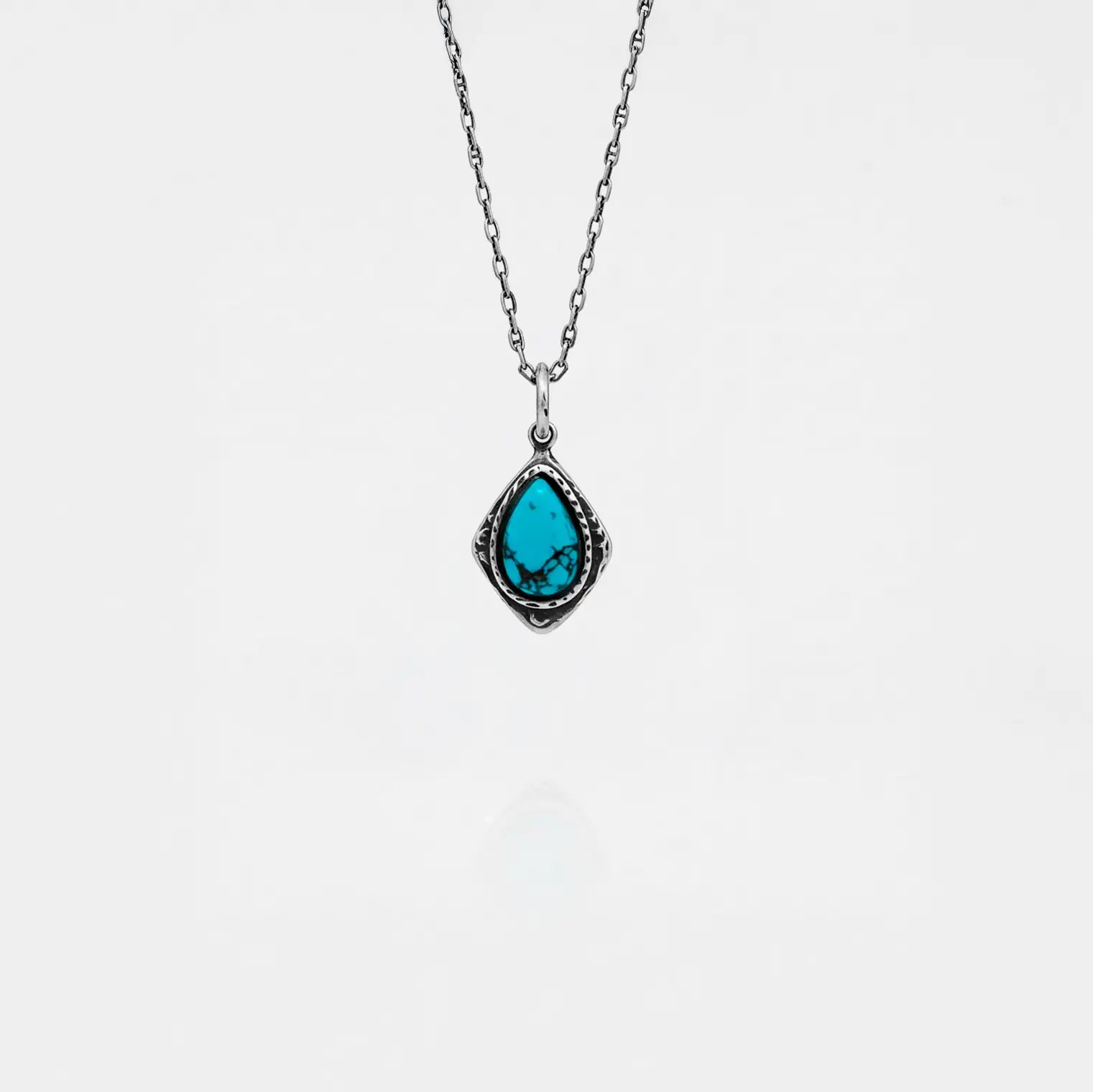 Necklace with a turquoise pendant on a white background