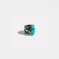 Silver ring with a turquoise stone on a white background