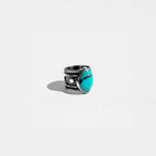 Silver ring with a turquoise stone on a white background