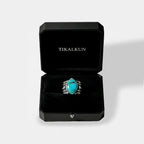 Turquoise ring in a black Tikalkun box on a light gray background