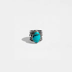Silver ring with a turquoise stone on a white background