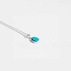 Silver necklace with a turquoise pendant on a white background