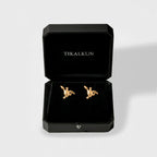 gold turtle earrings on a TIKALKUN jewelry box