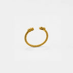Gold quetzalcoatl bracelet on a light gray background