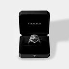 Silver velociraptor ring in a black Tikalkun jewelry box on a light gray background