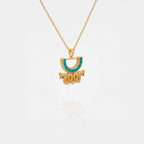 Gold aztec necklace with a half-circle pendant featuring turquoise color on a white background