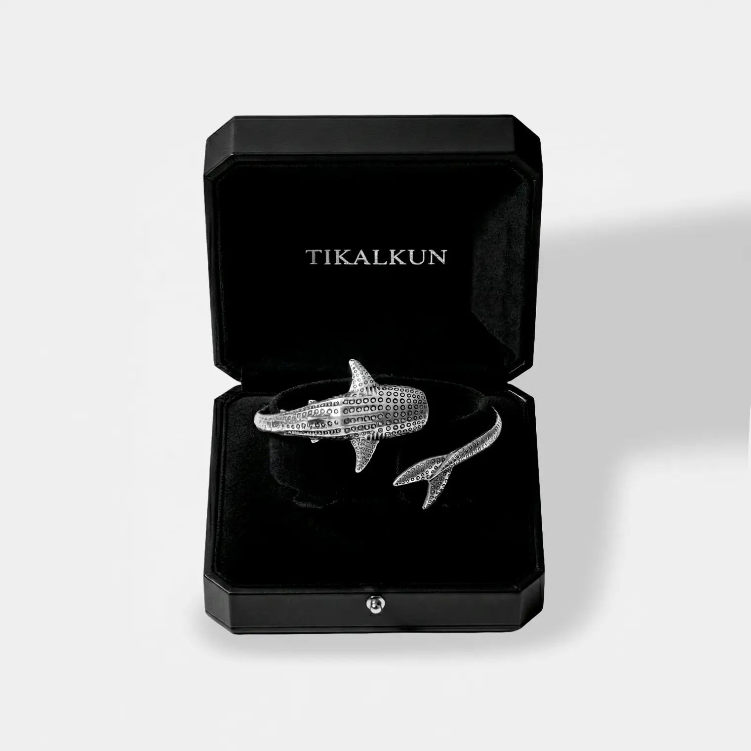 Silver whale-shark bracelet in a black Tikalkun box on a light gray background
