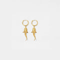 Gold whale-shark earrings on a light gray background