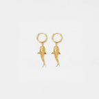Gold whale-shark earrings on a light gray background