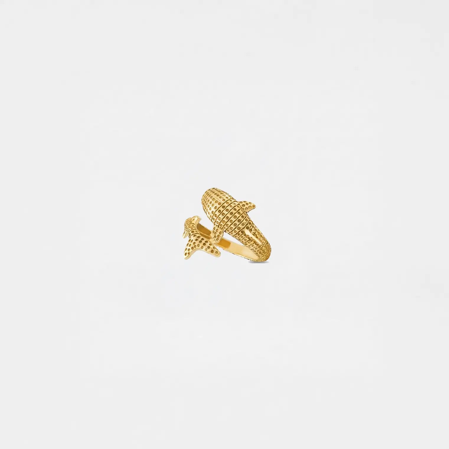 Gold ring shaped like a whale-shark on a light gray background